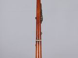 an image of a wooden bassoon on a clear surface