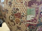 a large vase with a picture of a woman on it