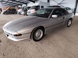 a silver car that is parked in a garage