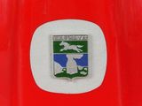 a close up of a red fire hydrant with a badge on it