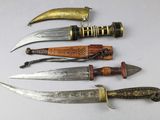 several different types of knives are lined up on a white surface