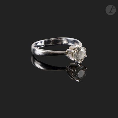 a close up of a diamond ring on a black surface