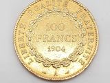 a close up of a gold coin on a white surface