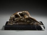 bronze sculpture of a woman laying on a marble base