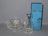 a glass vase and a glass bowl on a table