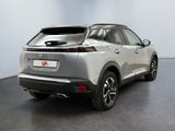 the rear end of a silver suv parked in a room