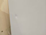 a white refrigerator sitting in the corner of a room