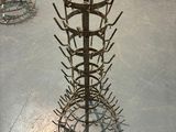 a metal rack with a bunch of nails on it