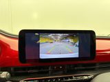 a car dashboard with a rear view mirror and a monitor on it
