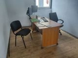 a desk with two chairs and a computer on it