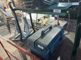 a blue tool box sitting on a table in a warehouse