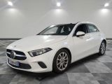 a white mercedes cla parked on a checkered floor