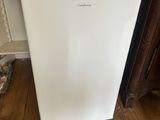 a microwave sitting on top of a refrigerator in a kitchen