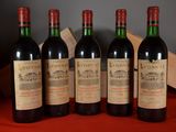 four bottles of wine are lined up on a table