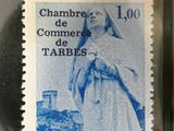postage stamp with a picture of a woman in a white dress on it