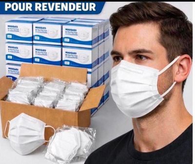 un homme portant un masque à côté d'une boîte de masques