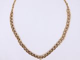 a gold necklace with a heart charm hanging from it