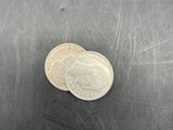 a small piece of metal that has a coin on it
