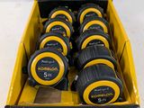 a box full of measuring tape in a cardboard box on a table