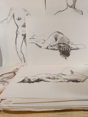 a lot of drawings of a man laying on a table