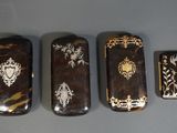 three lighters with designs on them sitting next to each other