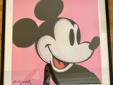 framed picture of mickey mouse on pink background in black frame