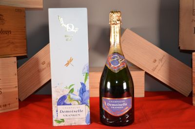 a bottle of champagne sitting next to a box of wine