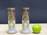 two vases sitting next to a green apple on a table