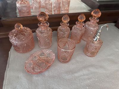 a lot of pink glass items on a table