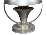 a silver lamp that is on top of a table