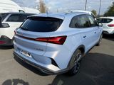 the rear end of a silver car parked in a parking lot