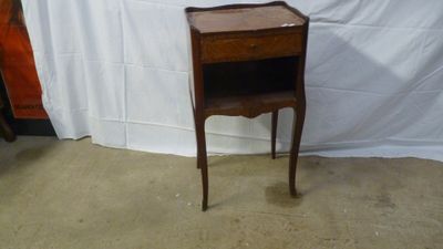 a small wooden table with a drawer on it