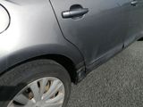 a car that has been dented and is parked on the side of the road