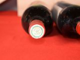two bottles of wine that are sitting on a table