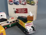 three toy vehicles and a book on the table