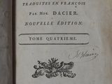 an old book with writing on it sitting on top of a table