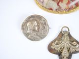 three pieces of jewelry are displayed on a white surface