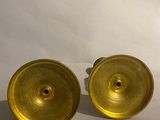 pair of brass plated candlesticks on a white background