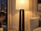 a living room with a couch and a table with a lamp on it