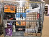 a large metal cage filled with various items in a warehouse