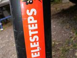 a close up of a sticker on a pole near a car