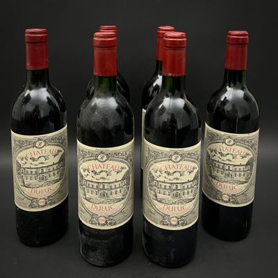 trois bouteilles de vin sont alignées sur une surface noire
