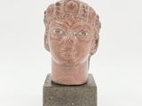 une image représentant une statue d'une tête posée sur un socle