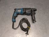 a drill and a cord on a metal surface