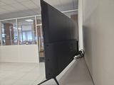 a flat screen tv sitting on a stand in a room