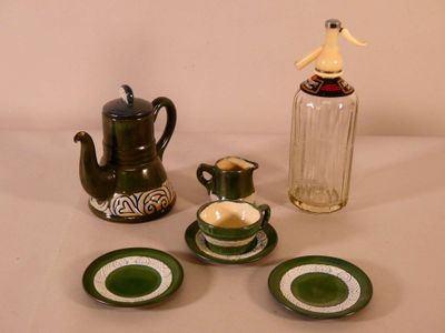 a tea pot, tea cup, and saucer sitting on a table