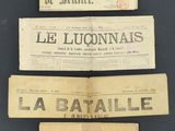 three old french newspapers are stacked on top of each other