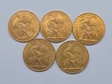four gold sovereigns, one of which is a lion and the other of which is a lion
