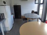 a table and chairs in a room with a large window