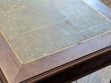 a table with a book on top of it on a wooden floor